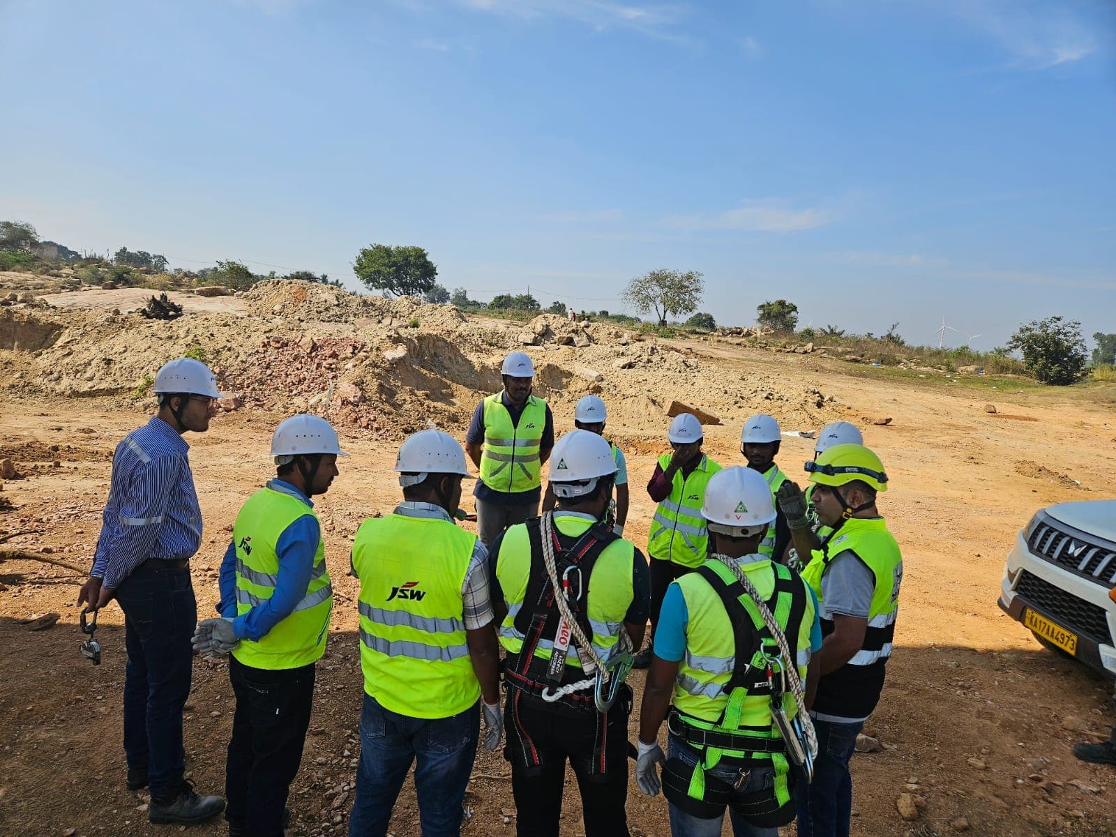 Trainees wearing full-body harnesses, hard hats and high-visibility vests before a work-at-height session