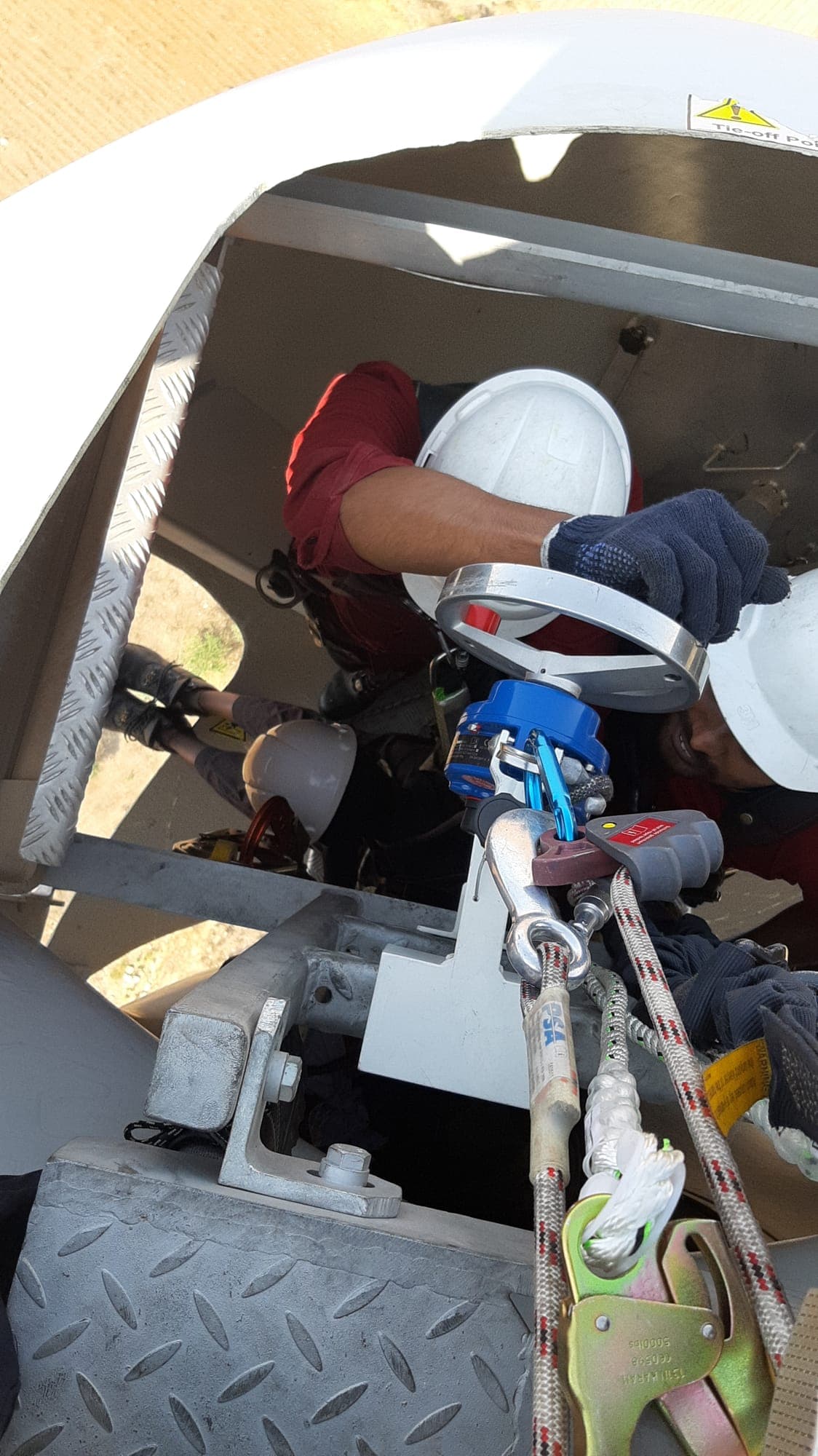 Rescuer working with a rigged rope system inside a wind turbine hub during advanced rescue training