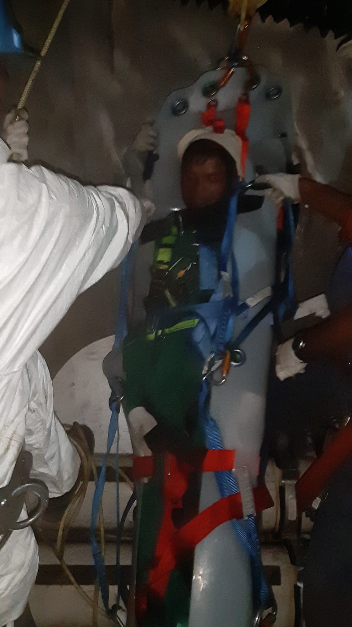 Volunteer casualty secured upright in a rescue stretcher being raised on a line during blade rescue training