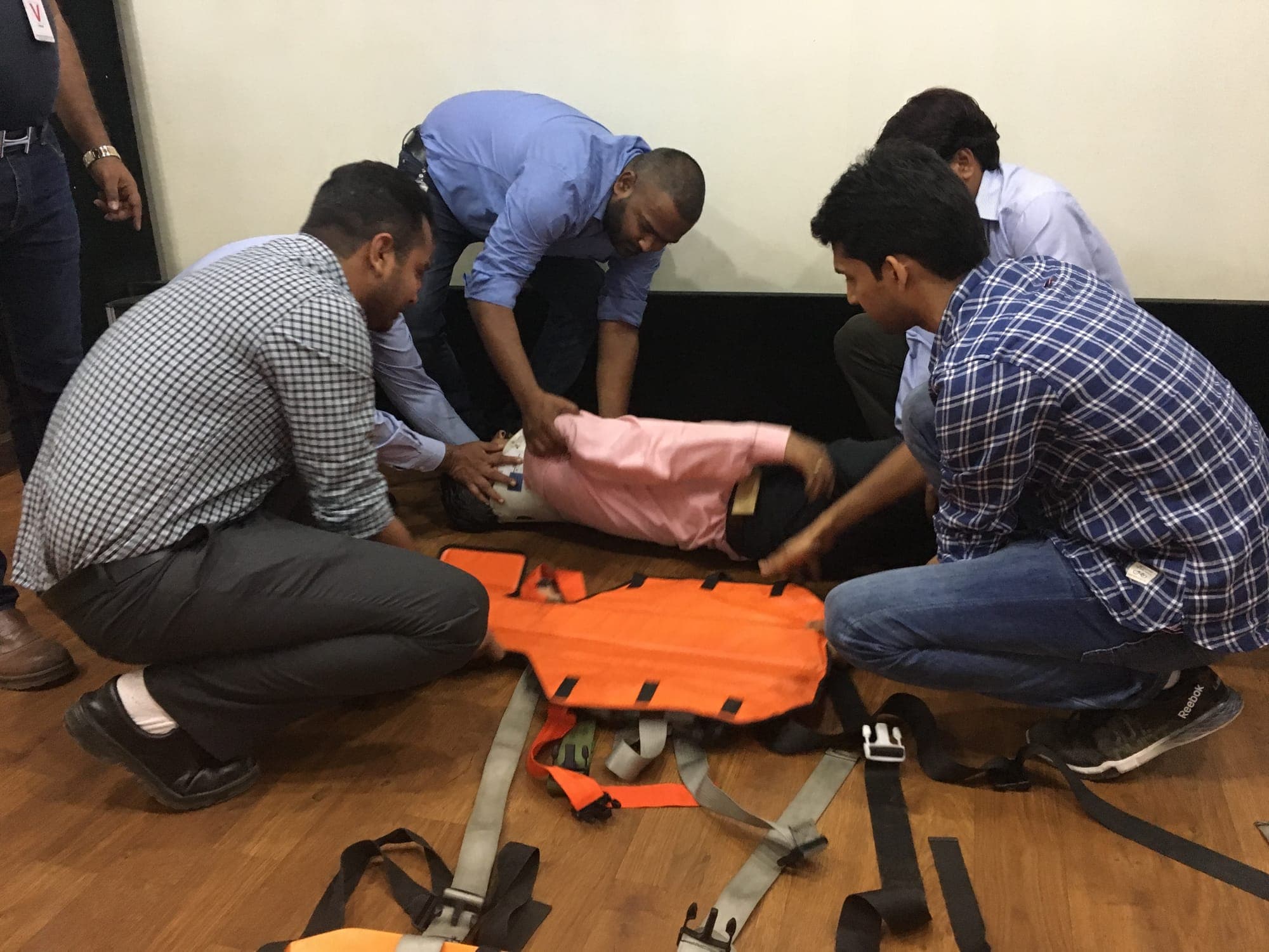 Team transferring a casualty onto a rescue stretcher during a casualty handling exercise