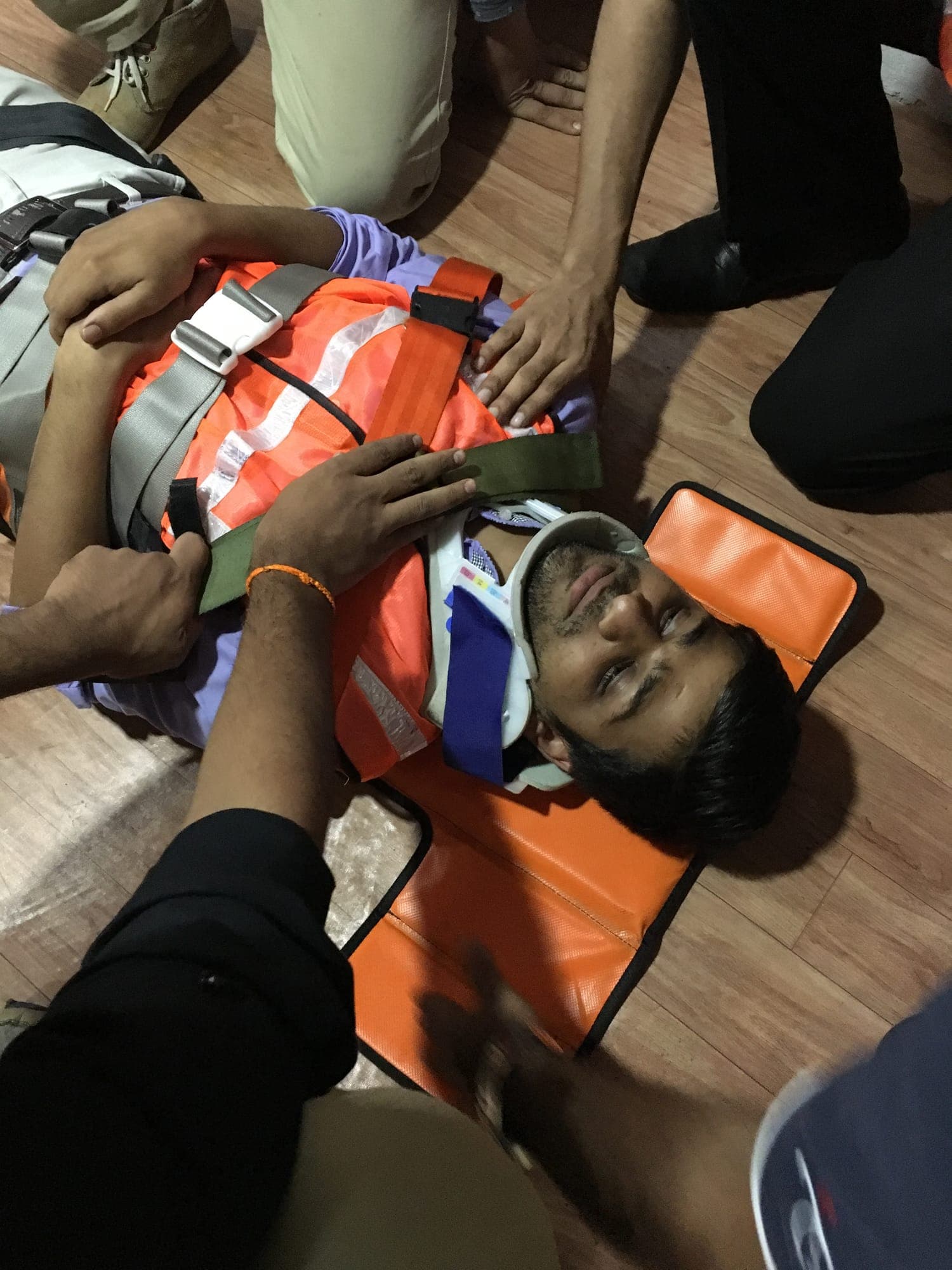 Casualty secured to a spine board with a cervical collar fitted during a rescue exercise
