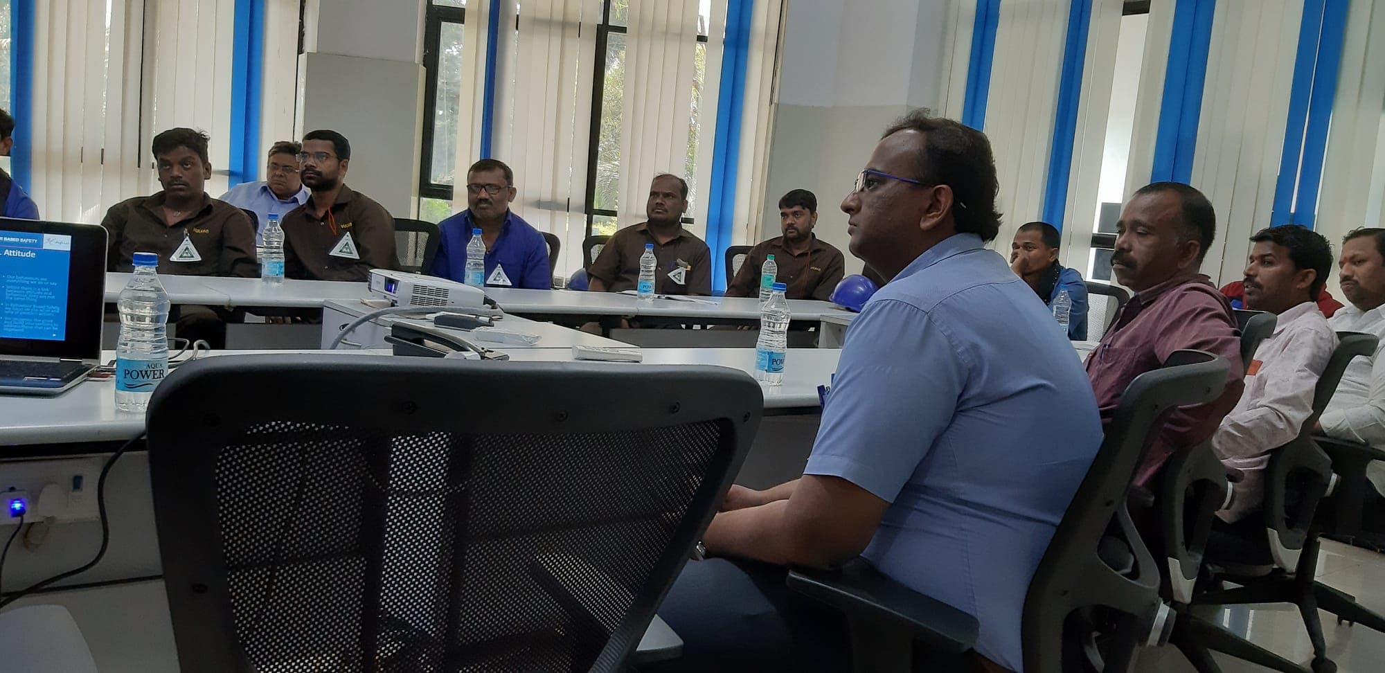 Trainer addressing participants during a group discussion in a behaviour based safety session