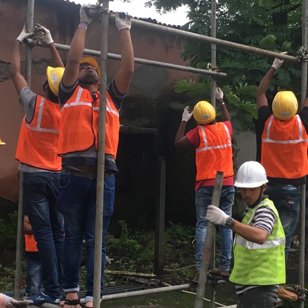 Participants fitting a horizontal scaffold tube and coupler during a hands-on exercise