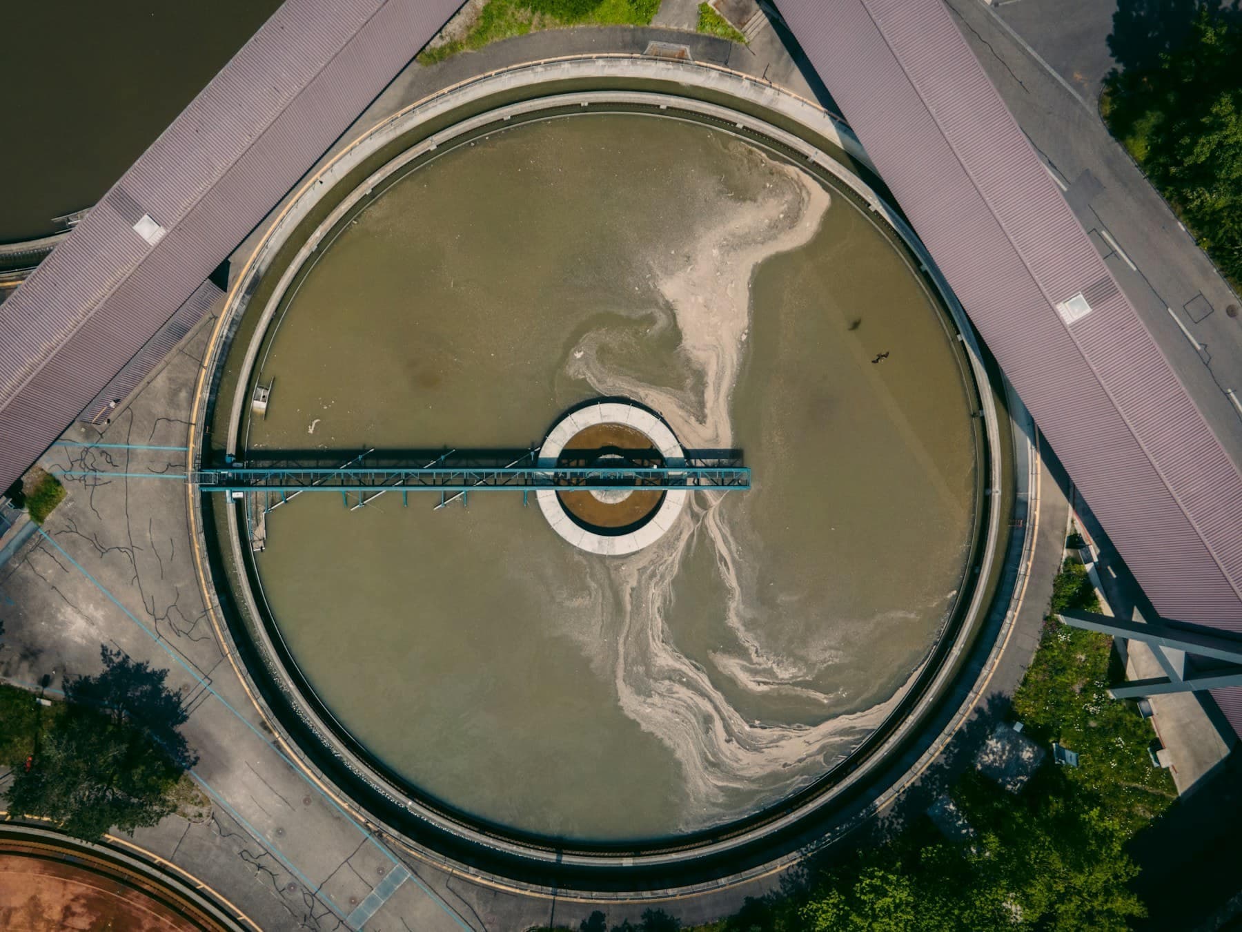 Aerial view of a circular clarifier tank at a municipal water treatment works