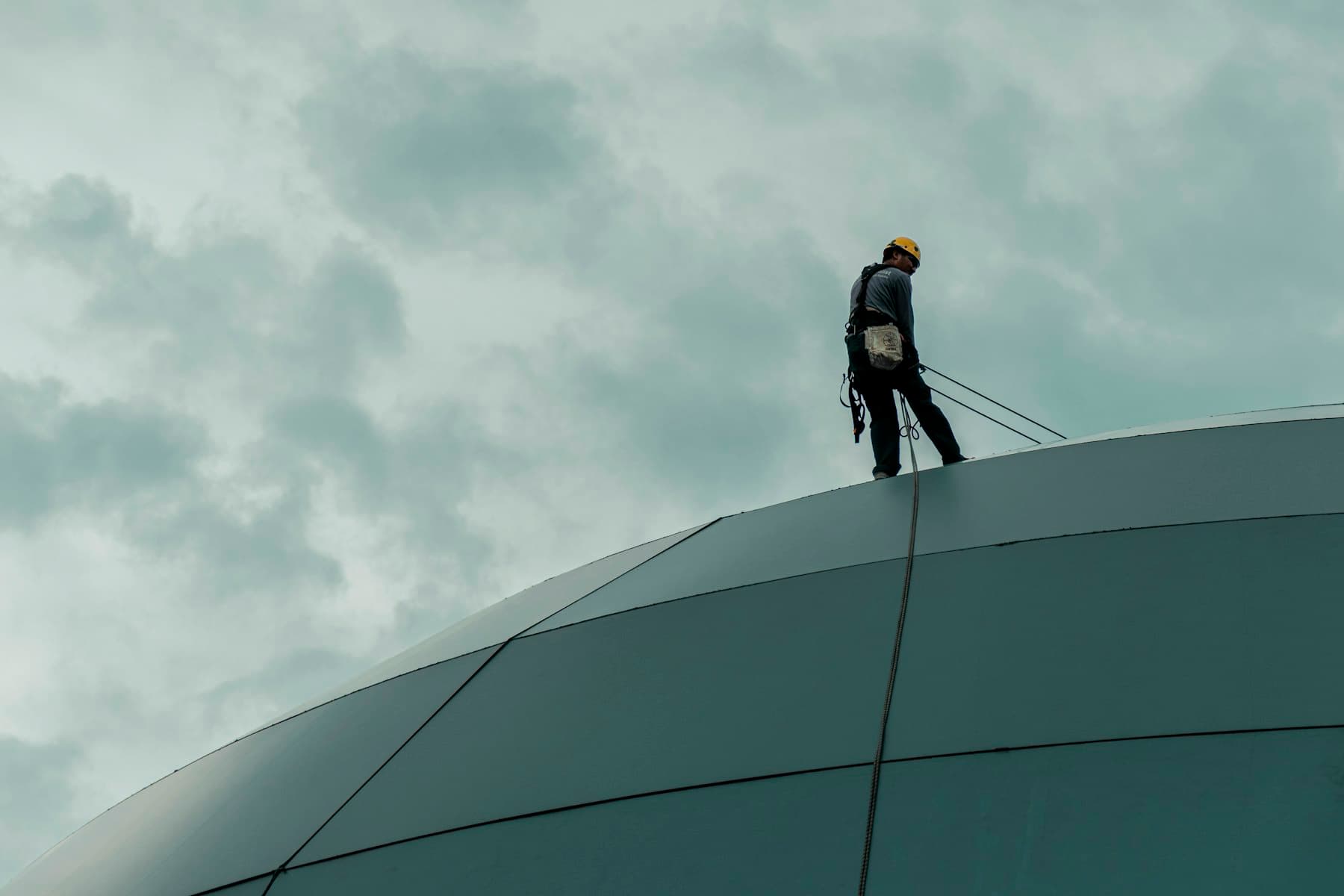 Technician connected to a vertical fixed line system on a tower