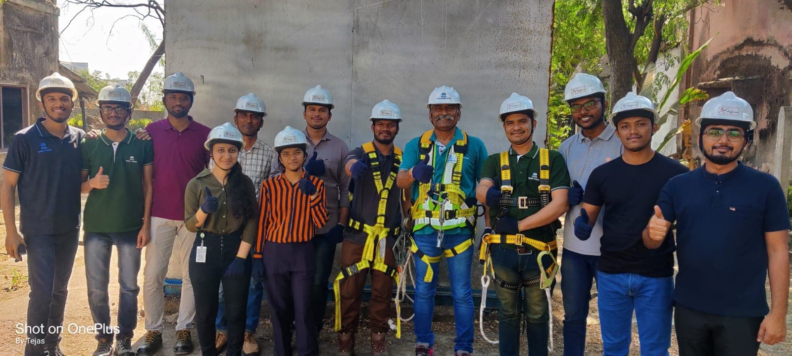 Group of work at height course participants wearing hard hats and full body harnesses