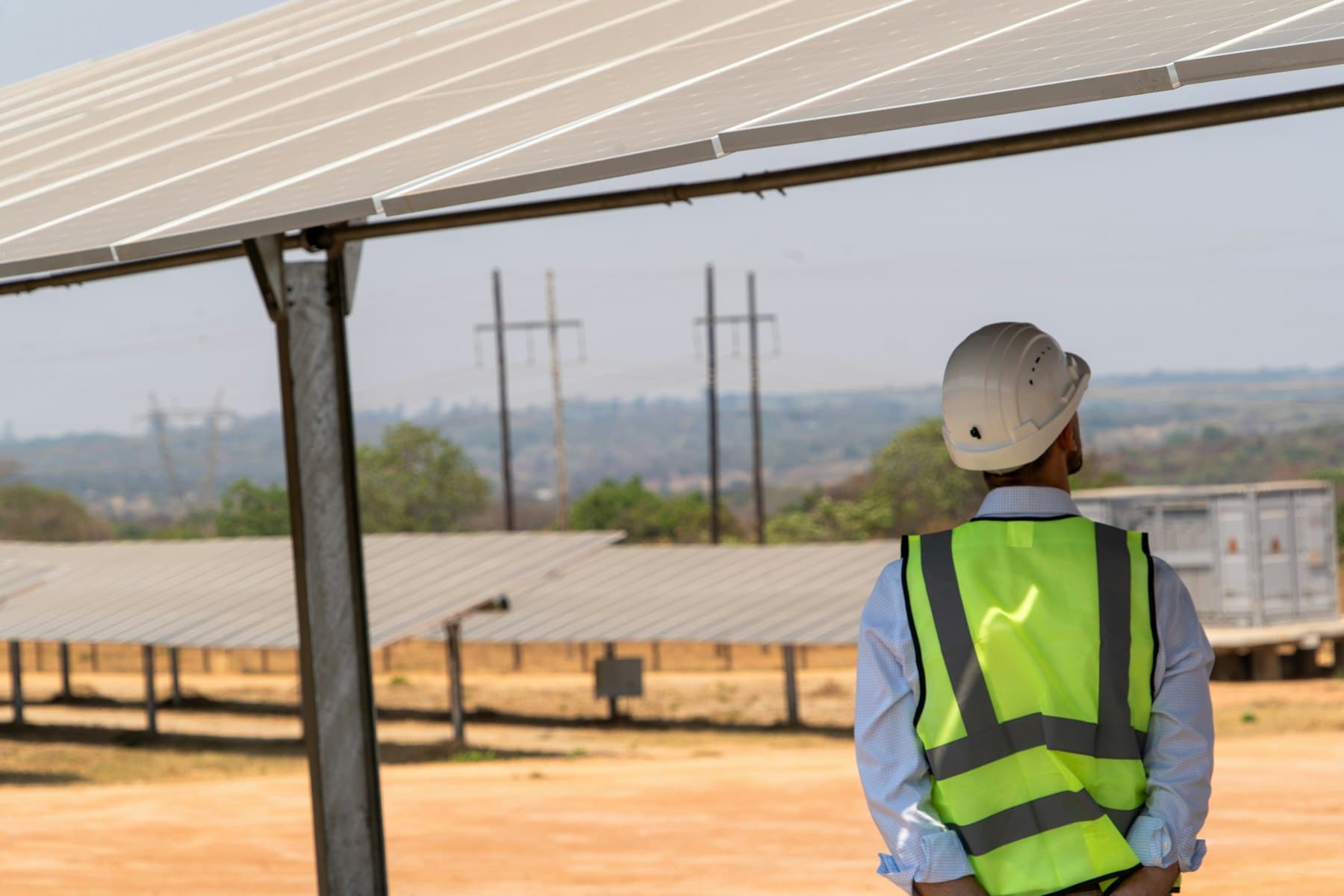 Technicians working across a utility-scale solar PV installation